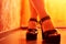 Close up of woman leg in black shoes. A woman& x27;s foot in shoes with a high platform and large heel. Rich orange lighting