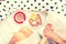 Close-up of woman legs and breakfast in bed with croissants, coffee and orange juice