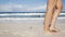 Close up of woman legs walking on beach