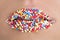 Close up of woman lips with multicolored pearls