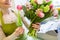 Close up of woman making bunch at flower shop