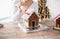 Close up of woman making gingerbread houses