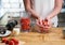 Close up of woman making strawberry smoothie. Healthy eating, cooking and summer refreshment concepts