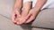 Close-up of a woman massage painful toes at home. Bare foot of woman with painful red bunion Hallux valgus and injury foot, Prob