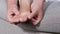 Close-up of a woman massage painful toes at home. Bare foot of woman with painful red bunion Hallux valgus and injury foot, Prob