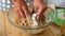 Close up of woman old mature hands prepare a tasty hand home made fruit pie for people at home - celebration together - grandmothe