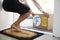 Close Up Of Woman Opening Front Door To Fresh Food Home Delivery In Cardboard Box Outside Front Door