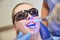 Close up of woman patient with dental curing light