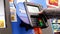 Close up of woman paying foods by credit card at self-check out counter