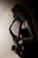 Close-up of woman playing saxophone, sepia toned.