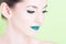 Close-up of woman posing with professional green trendy make-up