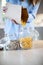 Close Up Of Woman Pouring Pasta From Plastic Free Packaging Paper Bag Into Storage Jar