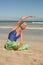 Close up of woman practising yoga while sitting on sand