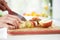 Close Up Of Woman Preparing Fruit Salad