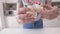 Close-up of woman preparing mushrooms for dish. Action. Young woman unscrews mushroom caps from legs and puts them on