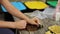 Close-up of woman preparing trash for recycling, squeezes an empty bottle. Woman caring for nature. Different colours of