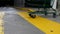 Close up woman pushing shopping cart walking on the yellow sidewalk in front of supermarket