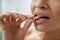 Close-up, woman puts a multivitamin pill in her mouth