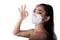 Close up of a woman putting on a respirator N95 mask to protect from airborne respiratory diseases as the flu covid-19 corona PM2.