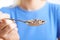 Close Up Of Woman With Quinoa On Spoon