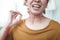 Close up of woman with rash on her neck taking necklace away