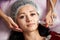 Close-up woman receiving electric ultrusound facial massage at beauty salon