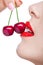 Close up of woman with red lips eating two berries