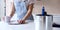 Close Up Of Woman Renovating Kitchen At Home Looking At Paint Swatches On Coffee Break