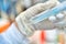 Close up of the woman researcher using pipette to resuspension of cells line in the research of drugs or chemicals in the laborato