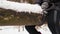 Close-Up, Woman in Rubber Boots Rides a Wooden Swing in a Winter Forest