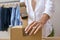 Close Up Of Woman Running Online Fashion Business Packing Up Order In Box With Tape Dispenser