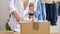 Close Up Of Woman Running Online Fashion Business Packing Up Order In Box With Tape Dispenser