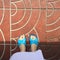 Close up of a Woman's Blue Slippers Buddhist Walking on Street or Ground for Relaxation and Meditation