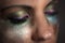 Close up of woman\'s closed eyes with colorful makeup