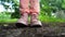 Close up of woman\'s feet in shoes on ground. Woman in pink sneakers stomping on ground.