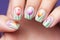 Close up of woman\\\'s fingernails with colorful tulip spring flower nail art design