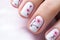 Close up of woman\\\'s fingernails with seasonal spring cherry tree flower nail art design