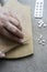 Close-up of a woman`s hand dividing pills with a knife