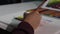 Close up, woman`s hand while she is drawing. Dolly shot