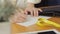 Close-up of a woman`s hand, a fashion designer drawing sketches of clothes in the atelier