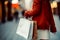 Close up of woman`s hand holding shopping bags while walking on the street