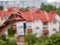 Close-up of a woman\\\'s hand with keys on the background of a built house.