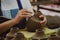 Close-up of a woman`s hand making patterns on a clay vase in a pottery workshop. Process of making a ceramic vase. handicraft and