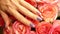 Close-up of a woman`s hand with manicure on nails stroking a luxurious bouquet of pink roses. A bouquet of roses as a gift to your