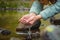 Close-up of a woman& x27;s hand pouring water from her palms while trying to drink from a clean water source in nature