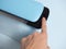 Close-up of a woman`s hand pressing the button of a blue vacuum packer. Concept of devices for food preservation and storage