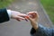 Close-up Of Woman`s Hand Putting Golden Ring On Man`s Finger