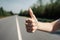 Close-Up Of A Woman\\\'s Hand With A Thumbs-Up Sign, Standing On The Side Of The Road Looking For A Ride - Generative AI