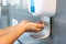 Close up of woman`s hand using alcohol gel disinfecting hands. Cleaning, washing hands using automatic sanitizer dispenser concep