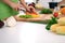 Close up of woman`s hands cooking in the kitchen. Housewife slicing fresh salad. Vegetarian and healthily cooking